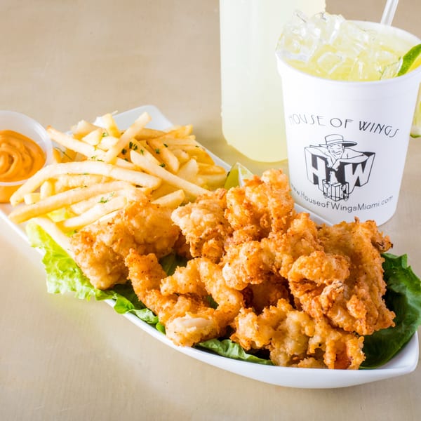 Crispy fried shrimp and french fries with dipping sauce and a House of Wings lemonade.